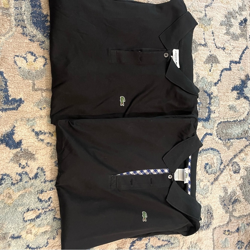 Men's black Lacoste polo shirts.